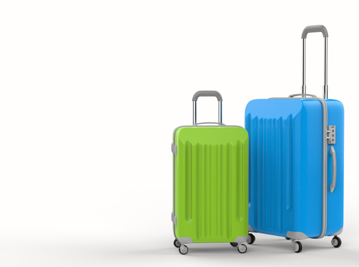 blue and green luggages on white background