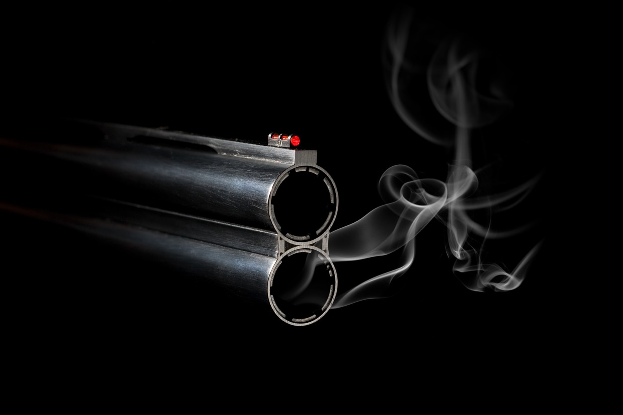 Gun Barrel with Smoke on black background